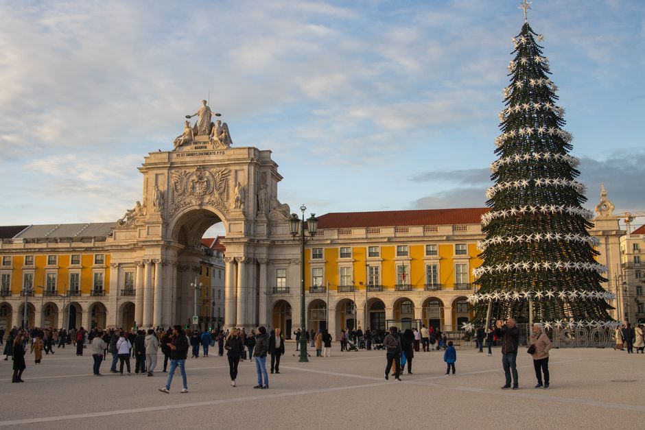 A festive day scene with a large Christmas tree at Praça do Comércio, Lisbon, Portugal.