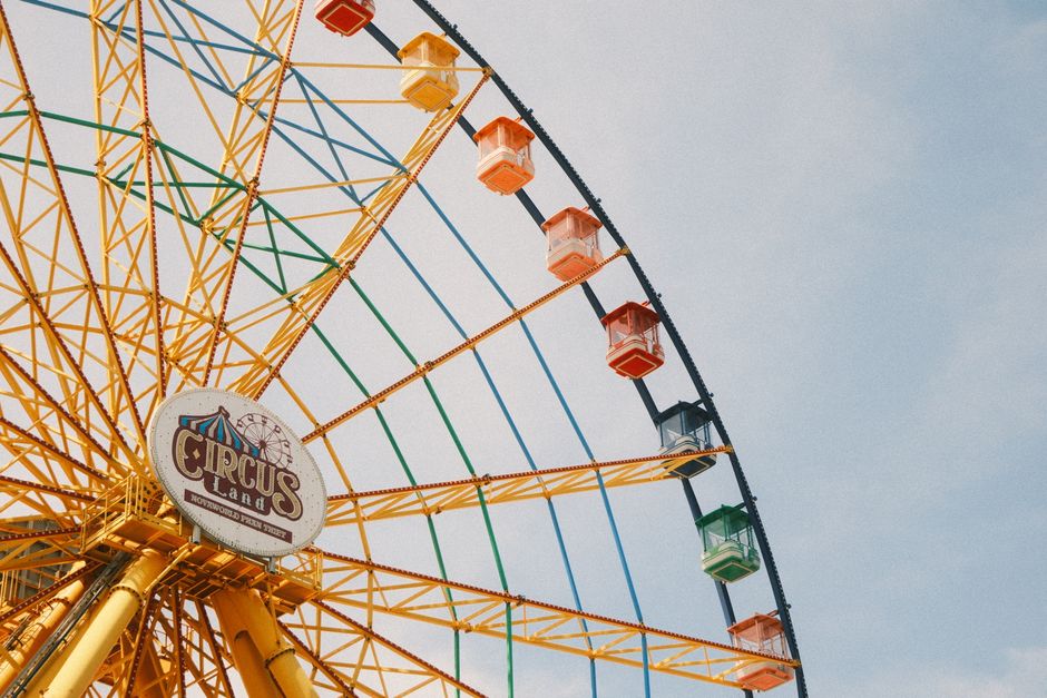 Close-up of colorful Ferris wheel at Circus Land in Vietnam under a bright sky.