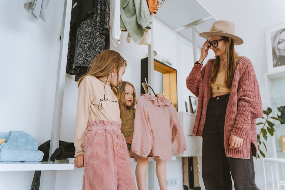 A mother and her daughters choose outfits in a stylish, cozy home setting.