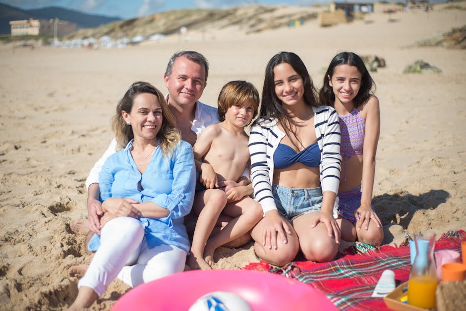 Smiling family enjoying a sunny day at the beach in Portugal.
