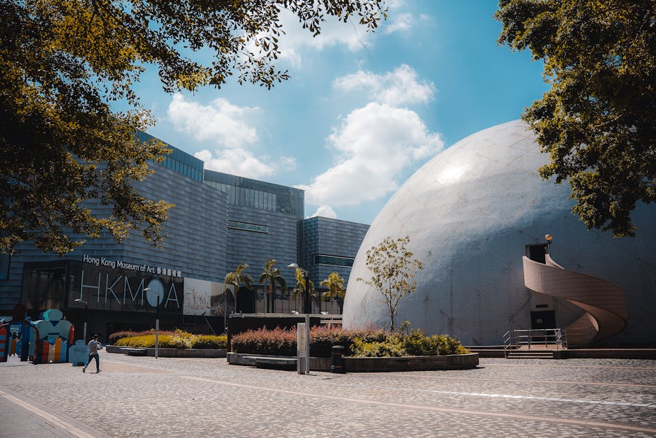 Photo of Hong Kong Space Museum dome and Hong Kong Museum of Art under a sunny sky.